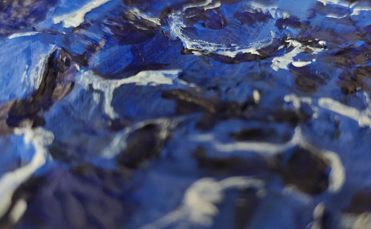 A close raking-light detail of the same relief sea-painting, showing sculpted ridges of blue paint and white foam standing in three dimensions.