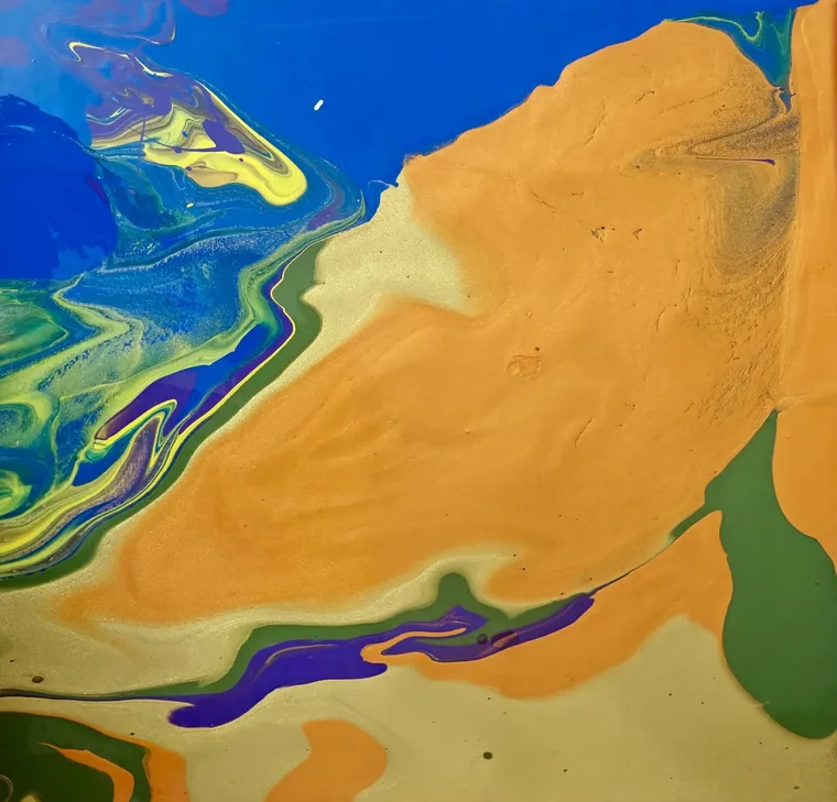 Cobalt water meeting orange and green land, like a river delta photographed from orbit.