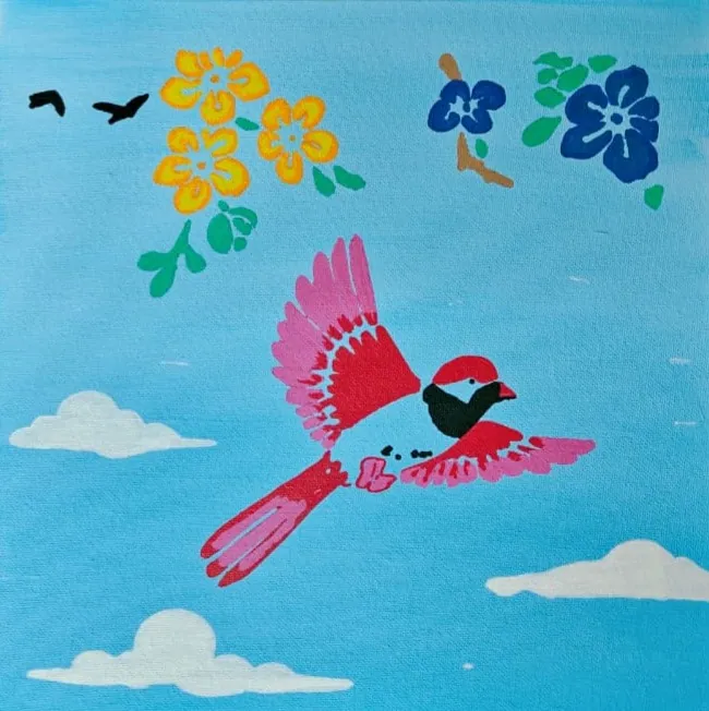 A flat-colour painting of a crimson and pink bird in flight with its wings spread, against a bright blue sky with white clouds, sprays of yellow and blue blossom above, and two small dark birds in the distance.
