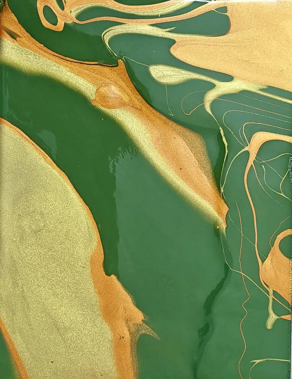 Emerald green and metallic gold marbled into stone-like veins.