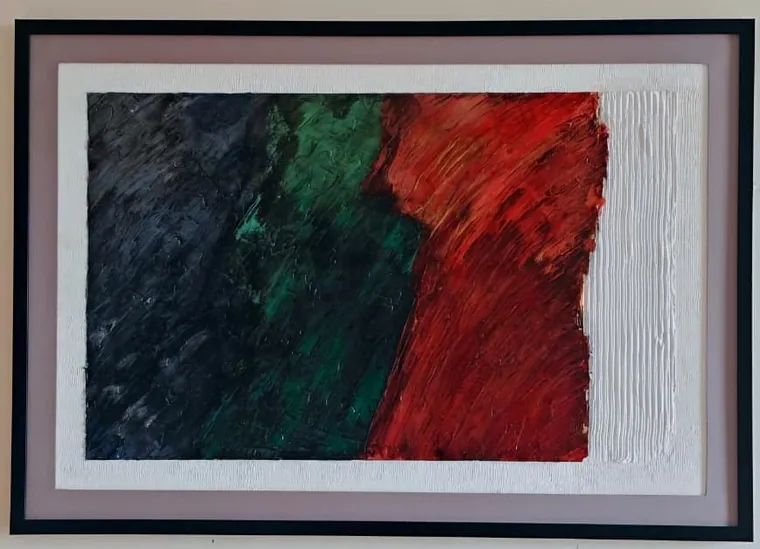 A framed textured abstract painting: broad knife-laid bands of blue-black, deep green and crimson red running left to right across the canvas, meeting a raked white impasto margin at the right edge, in a black frame.