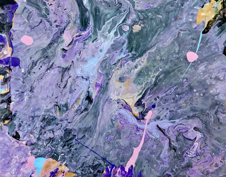 A marbled pour of slate grey and lavender scattered with droplets of pink and gold, like weathered stone.