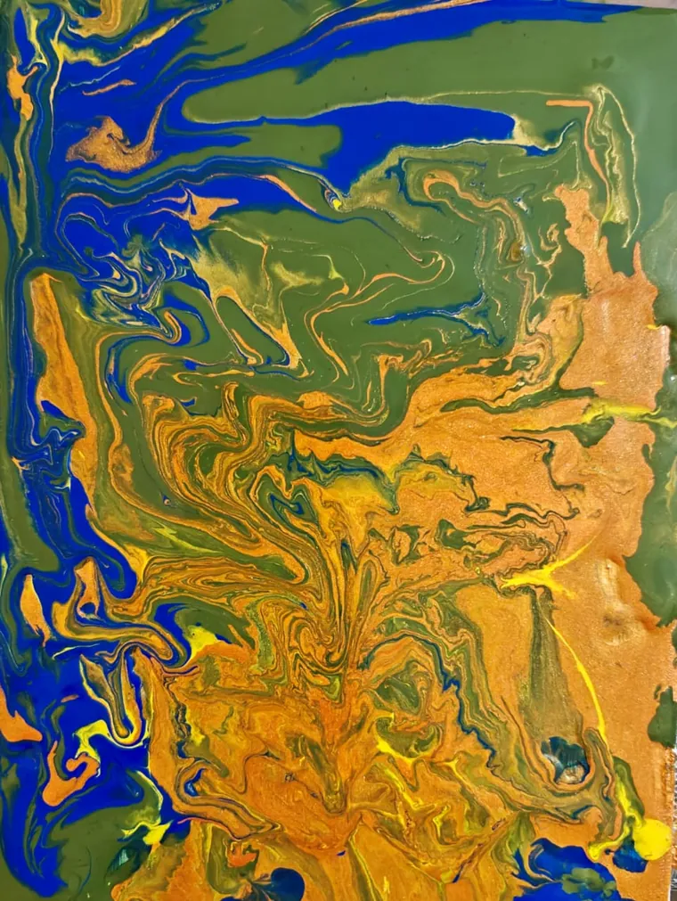 Cobalt blue threading through green, orange, and gold poured paint, like water meeting land seen from above.