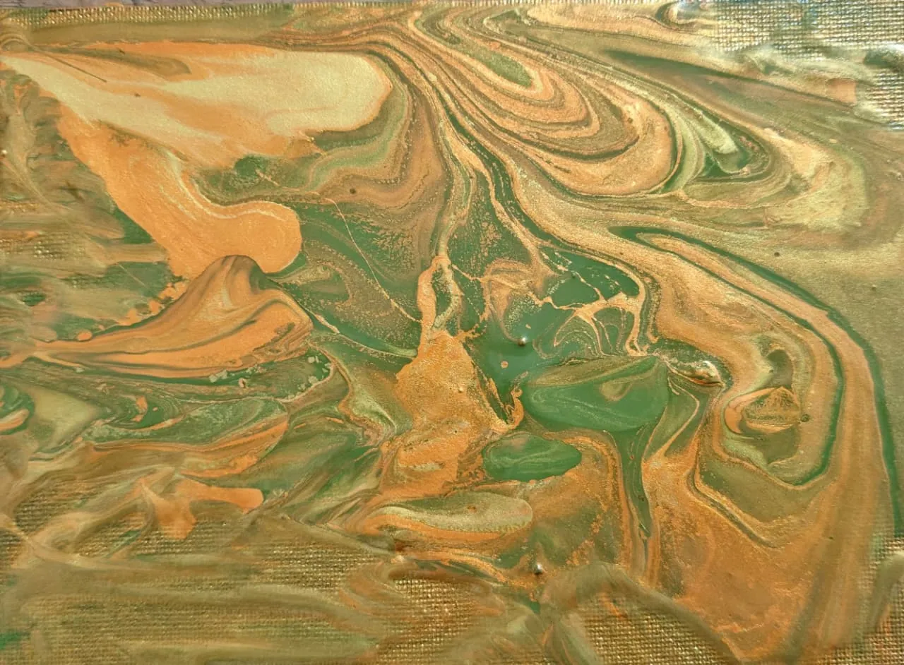 Swirls of copper, gold, and green resembling oxidised metal and ore.