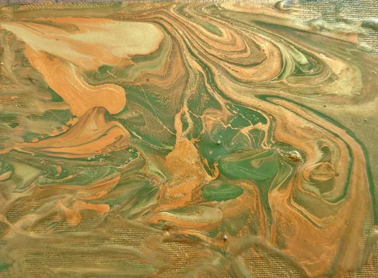 Swirls of copper, gold, and green resembling oxidised metal and ore.